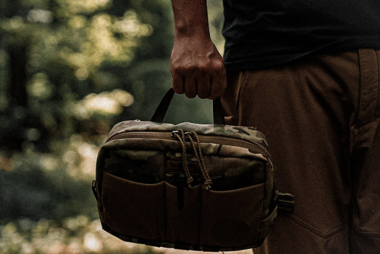 a man holding onto a chest rig