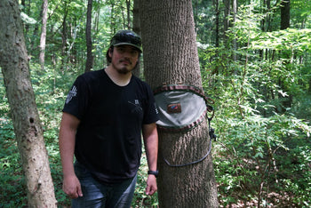 drew eyink standing next to a tree with a bullpath saddle