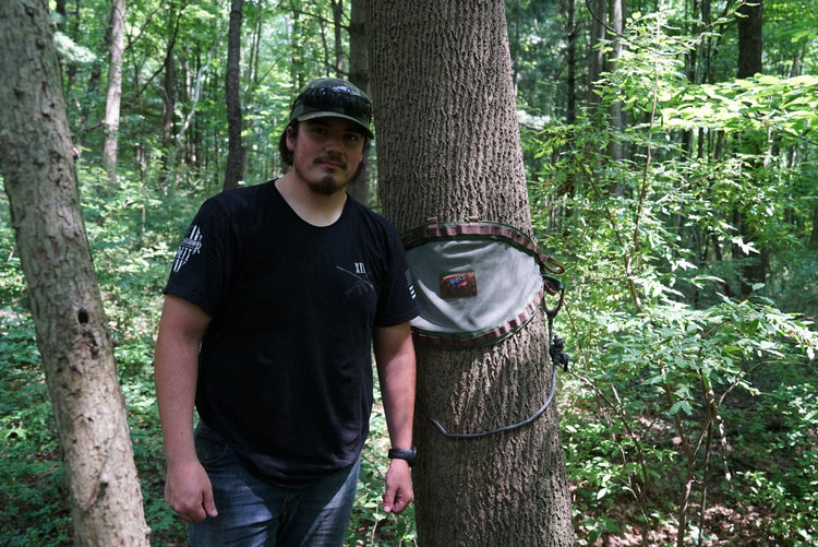 drew eyink standing next to a tree with a bullpath saddle