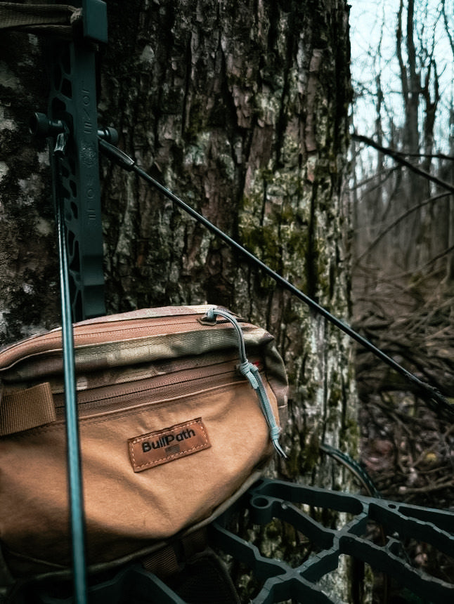 a camo treestand pouch on a treestand up in a tree