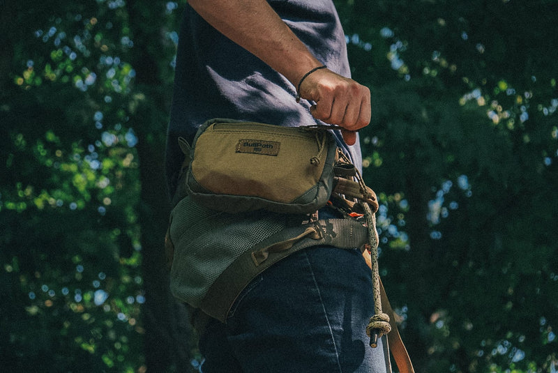 Load image into Gallery viewer, close up shot of a saddle hunter utilizing the small BullPak x in the El Toro hunting saddle in the woods.
