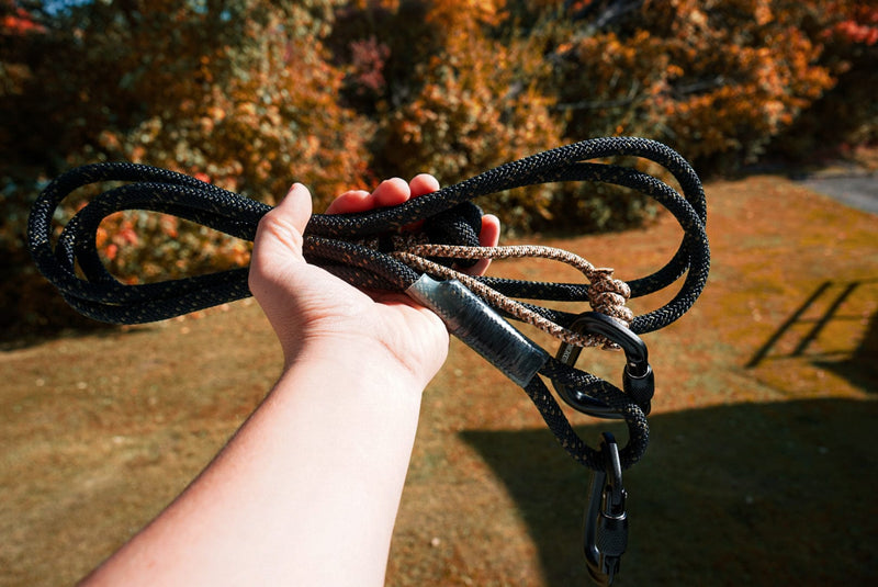 Load image into Gallery viewer, Black lineman rope coiled up in hand
